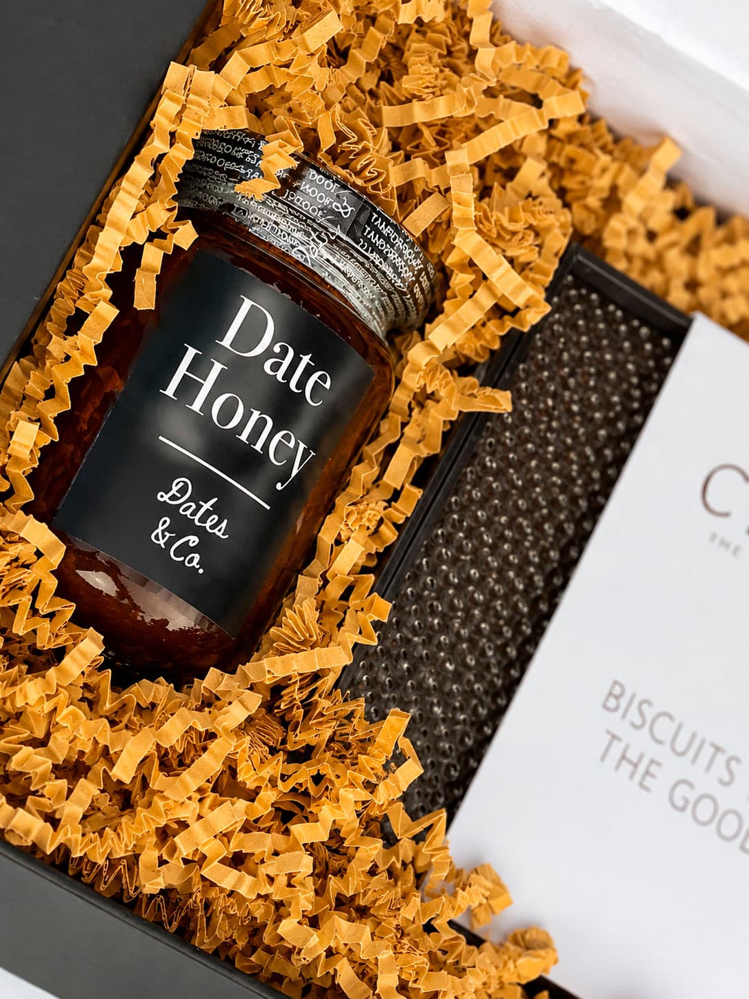 Date honey bottle presented in a gift box