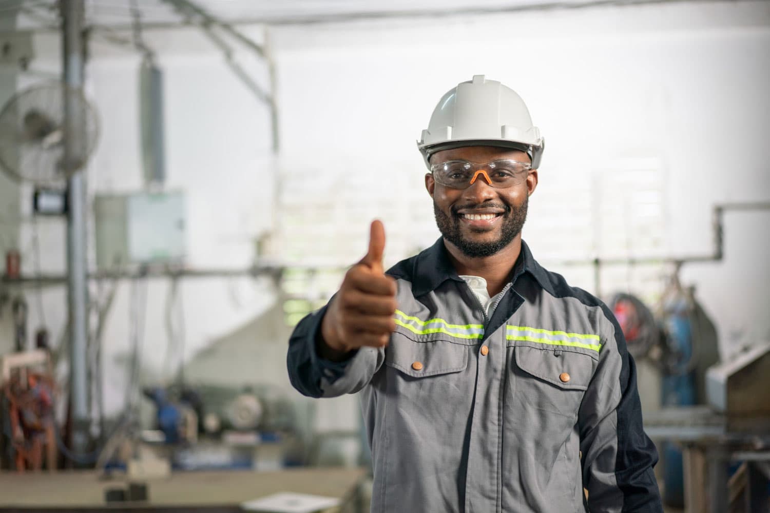 Operations worker in safety gear giving a thumbs-up
